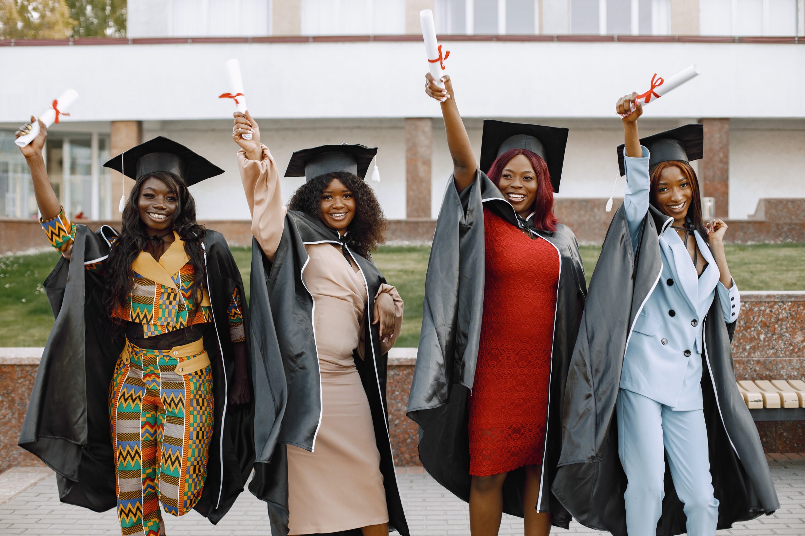 group young afro american female student dressed black graduation gown campus as background scaled